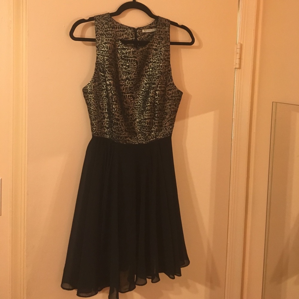 Gold metallic and black cocktail dress.