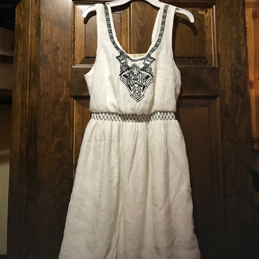 White dress with navy blue accents