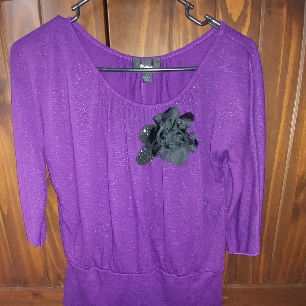 Purple/silver sweater, with attached black,flower.