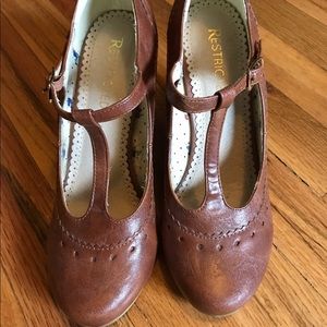 Restricted T-strap wedge heels.