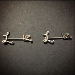 Nipple rings that spell "love"