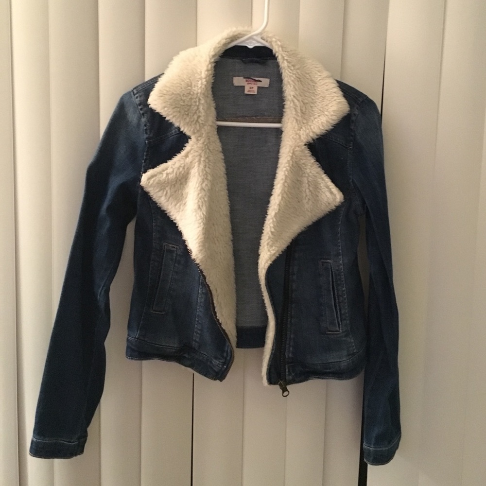 Blue jean jacket with fur trim.