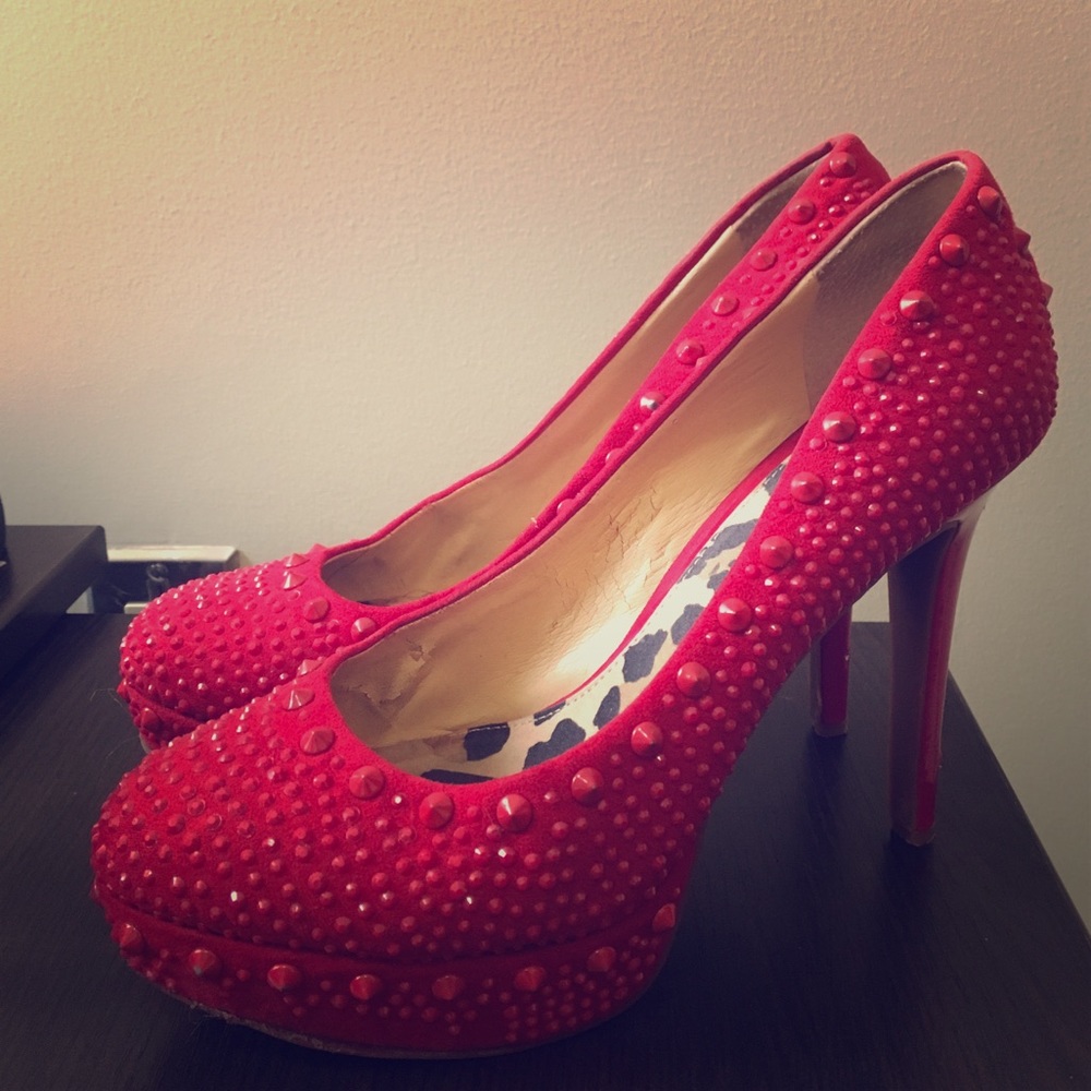 Bright red pumps with shiny studs