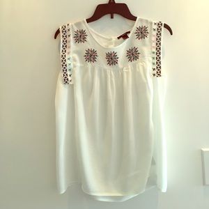 White sleeveless top with embroidered detail