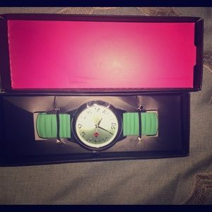 A silver rounded lime green watch
