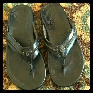 Olukai  black flip flops
