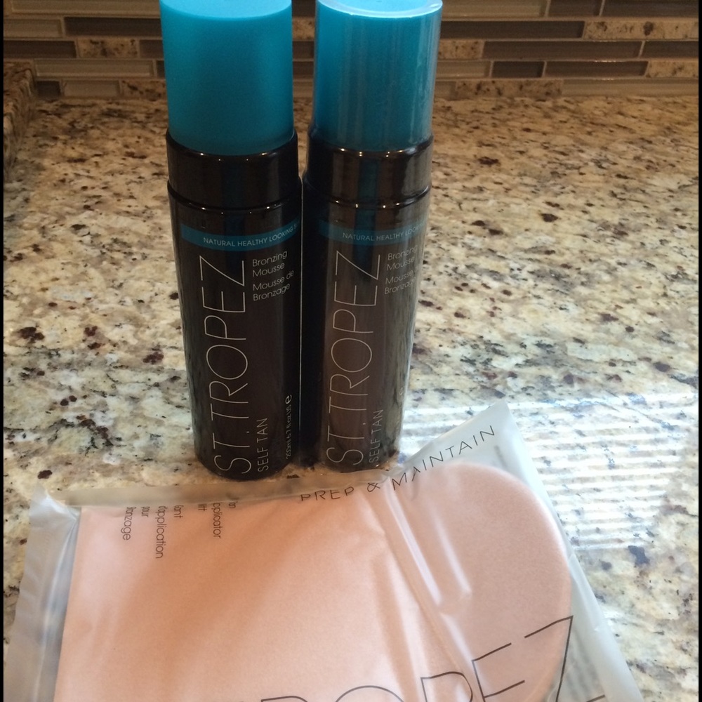 Two bottles of St.Tropez self tanner with glove