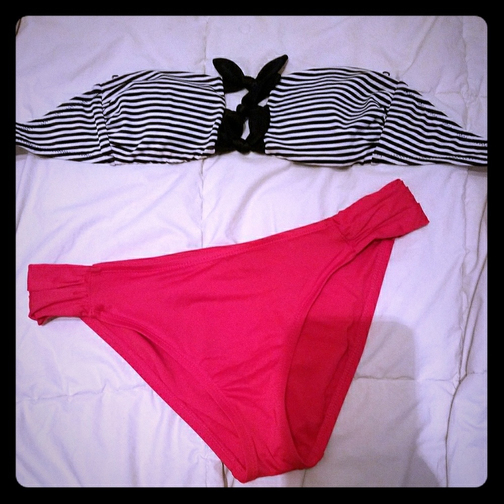 Striped strapless swim top and red swim bottoms