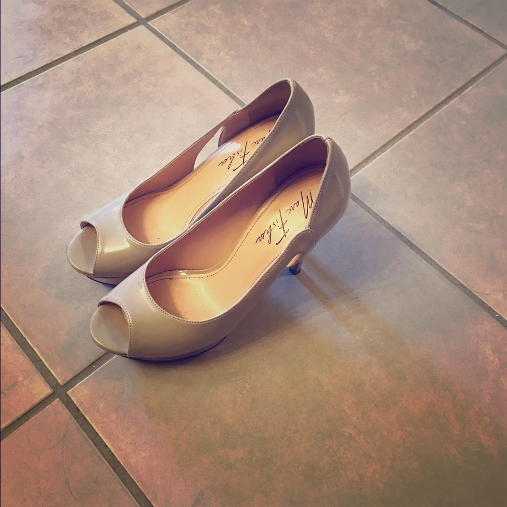 Nude open toe platform pumps.