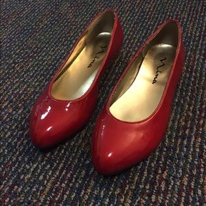 Patent leather red flats with a small heel. Size 6