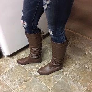 Darker brown knee high boots, with strings in back