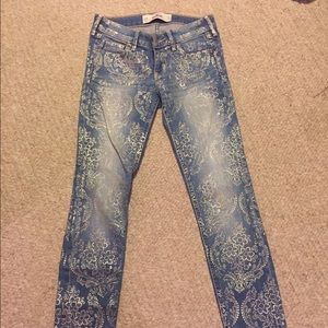 Hollister jeans with gold stamped design.