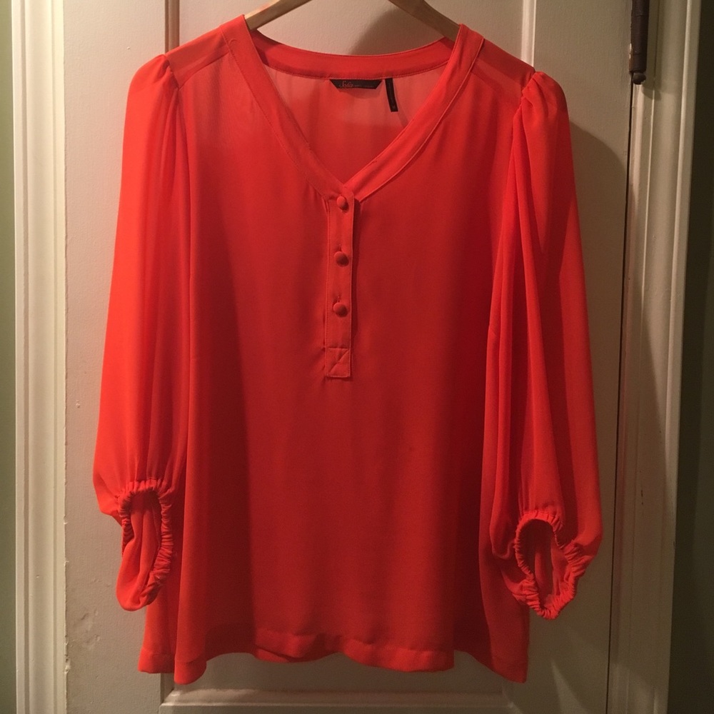 Sofia Vergara neon orange chiffon blouse