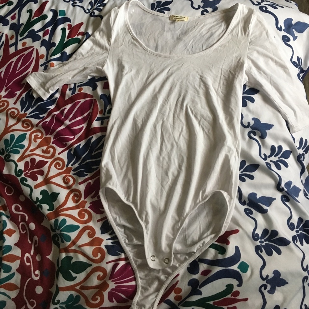 Two plain white bodysuit