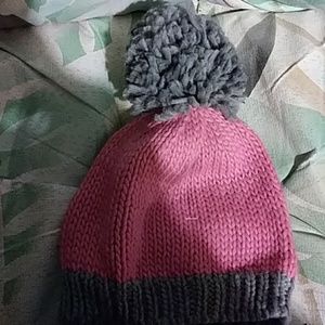 Pink and gray hats with pom poms