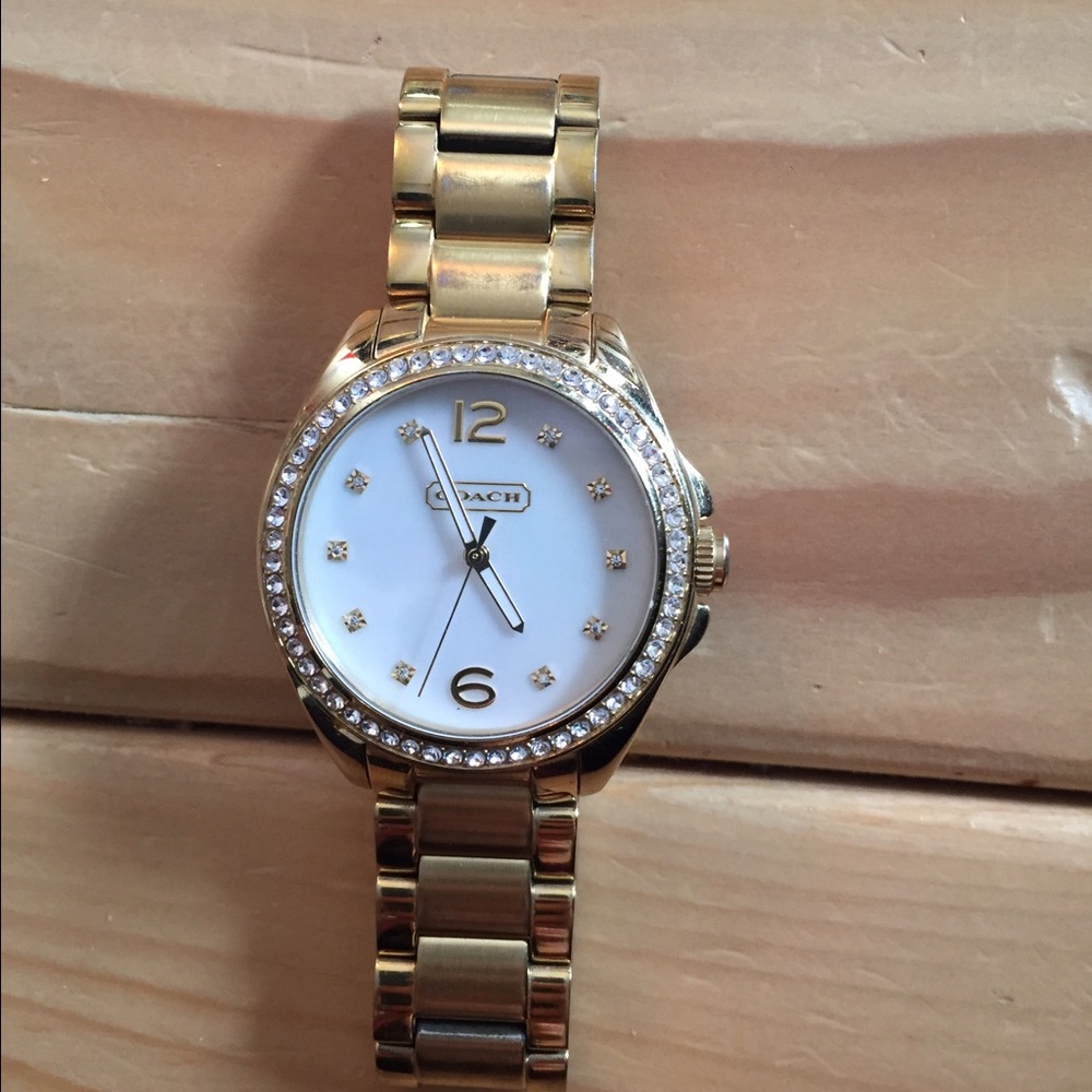 Women's gold pearl face Coach watch