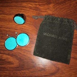A green Michael Kors earring and ring set
