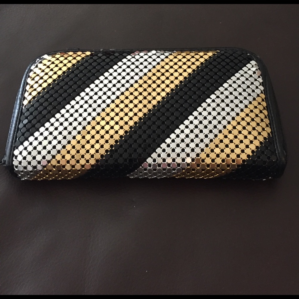 Silver/gold/black wallet with detachable strap.