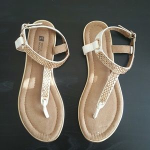 White sandals with gold embellishment