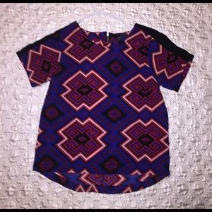 A very bold, red, black, white, & blue blouse!