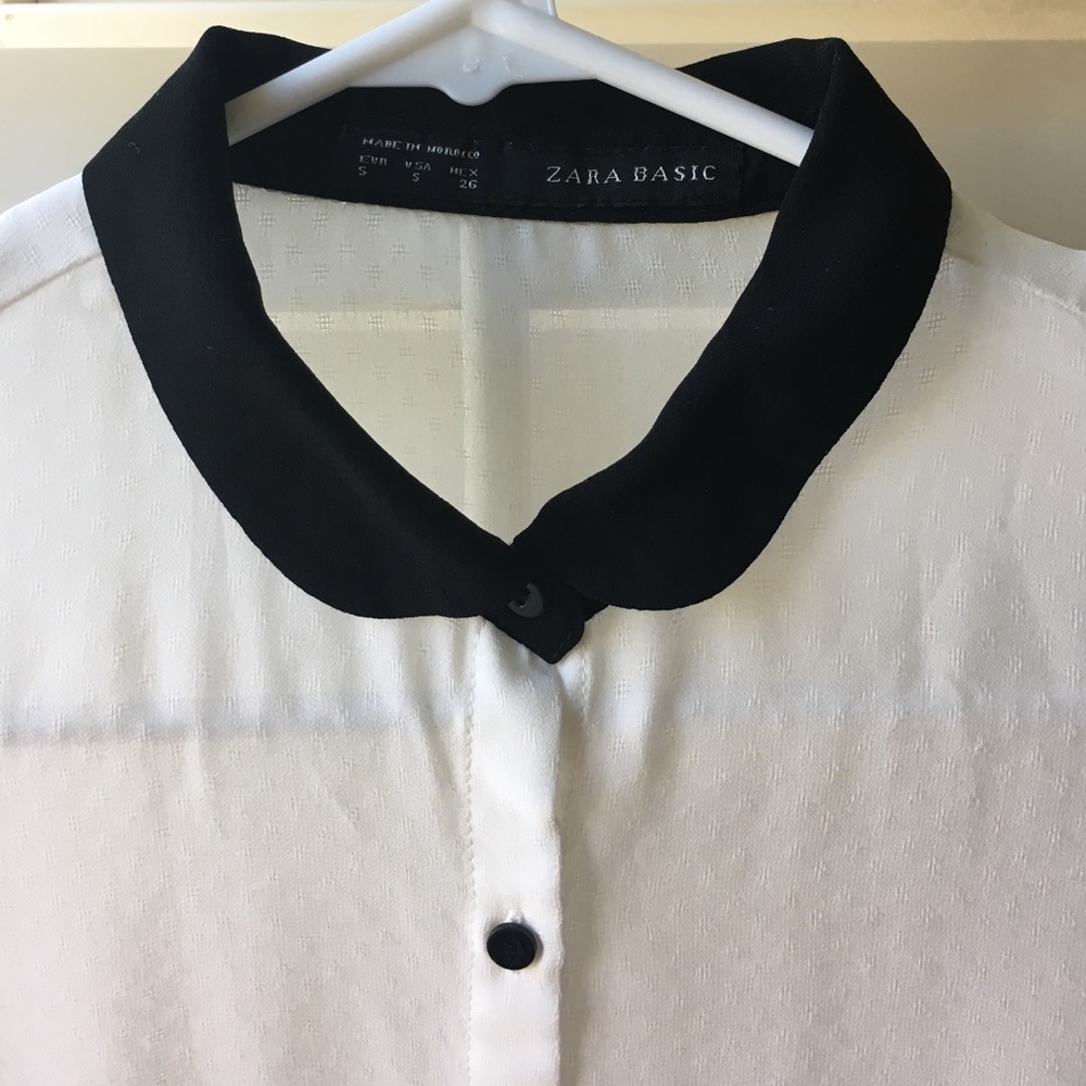 Sheer white blouse with black trim