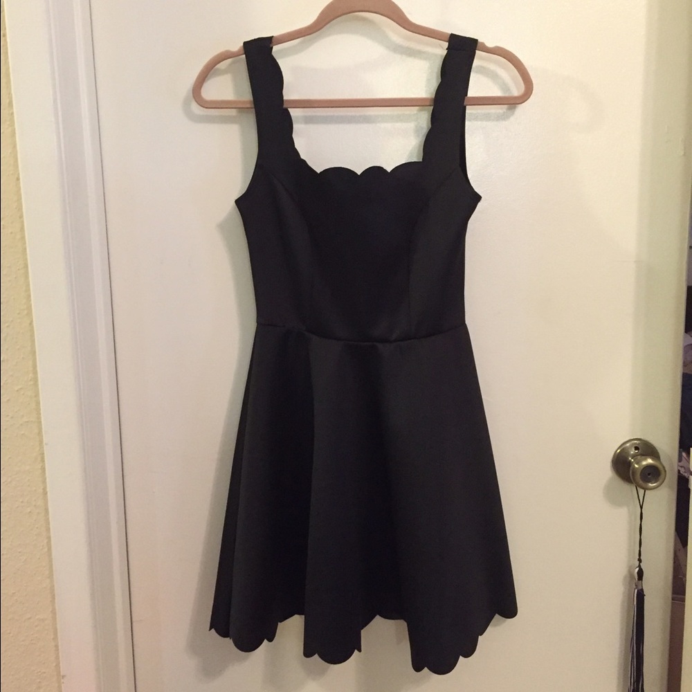 Black dress with scalloped edges.