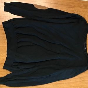 Black sweater, detail on the elbows.