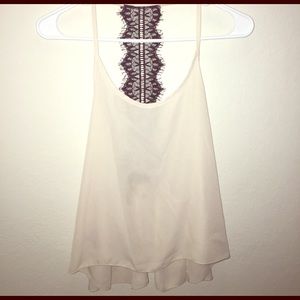 Cream tank top with a lace back on spine