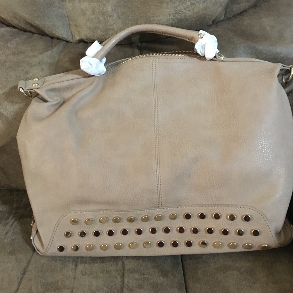 Tan leather purse with gold grommets