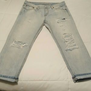 Light wash destroyed boyfriend jeans.