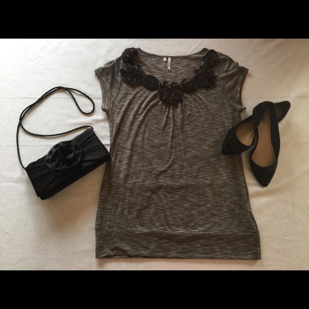 Grey top with rose appliqué neckline.