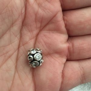 Silver charm with light blue accents