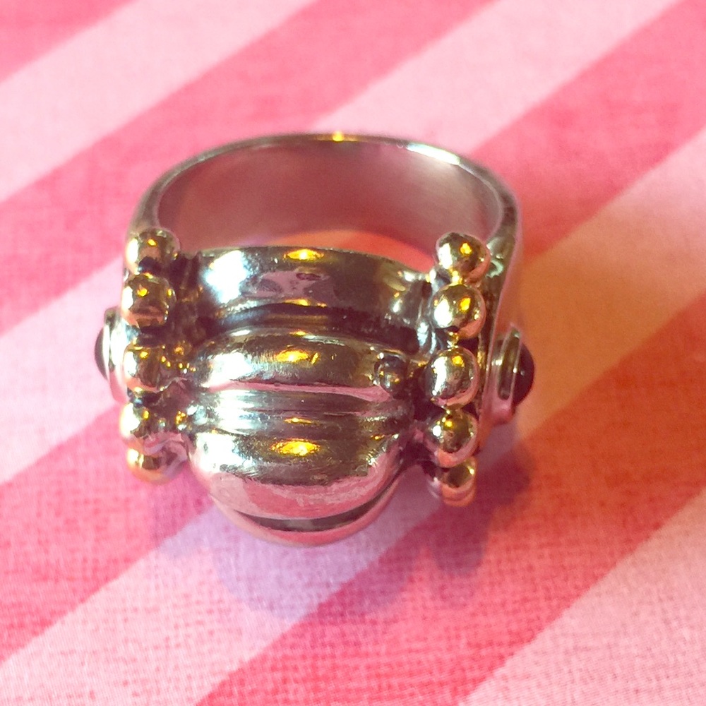 Silver with gold tone ring.