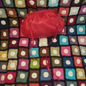 GENTLY USED RED LEATHER WITH SKIN TRIM BAG