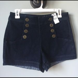 Denim high rise shorts with anchor buttons.