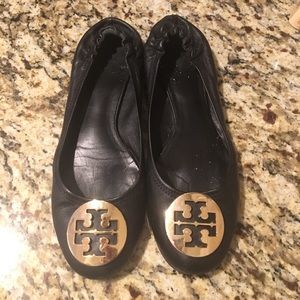 Tory Burch black leather flats with gold medallion