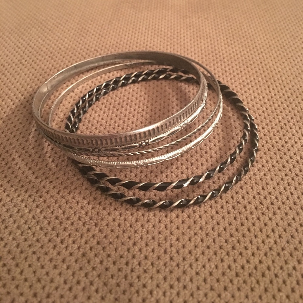 Sliver and black bangle bracelets.