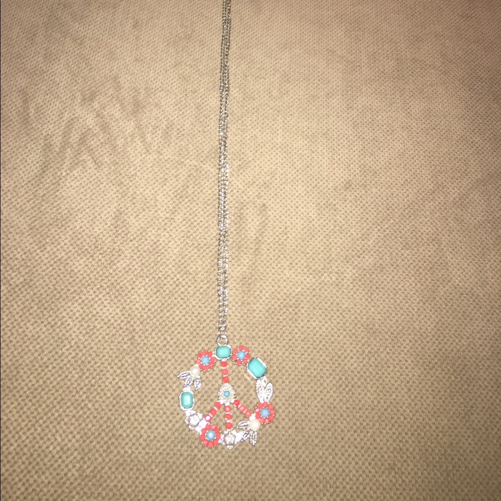 Flower peace sign necklace.