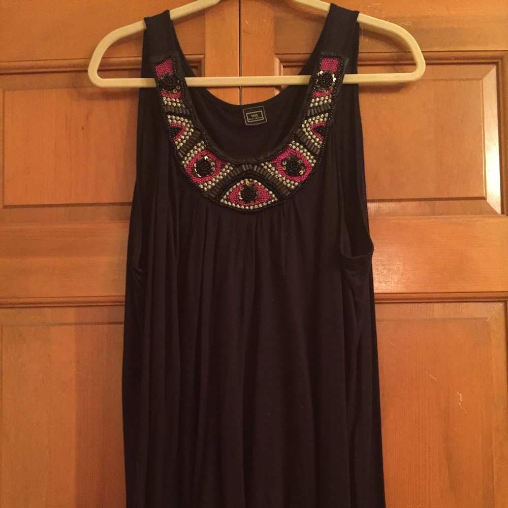 Black sleeveless top with beading.
