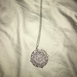 Long silver necklace with medallion