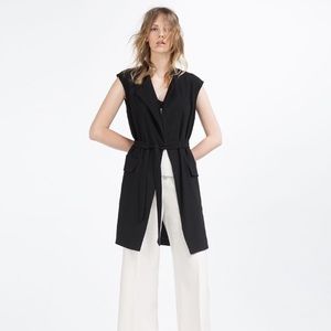 Black long sleeveless waistcoat