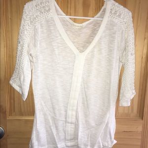 White shirt with braided sleeves.