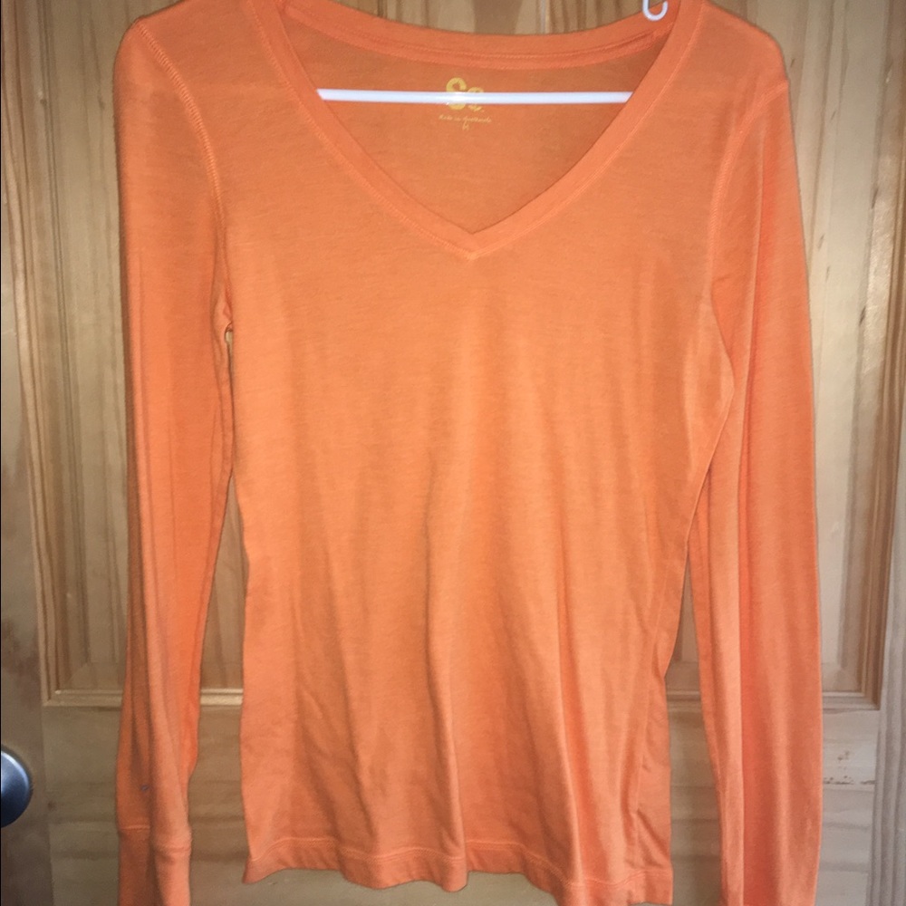 Orange long sleeve top.