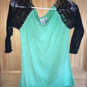 Green top with black flower sleeves.