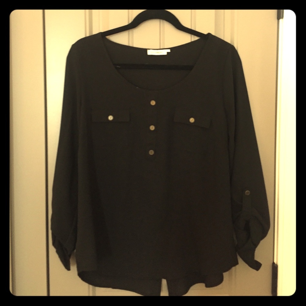 3/4 sleeve blouse, buttons up the back.