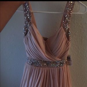 Light blush pink short sleeveless dress.