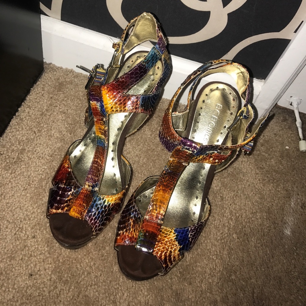 Pair of brown snakeskin ankle strap peep toe heels