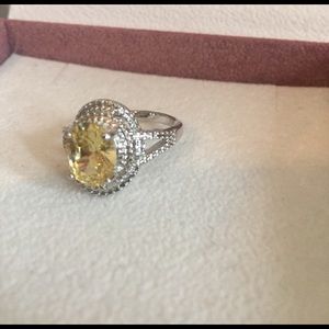 Silver band with a yellow stone