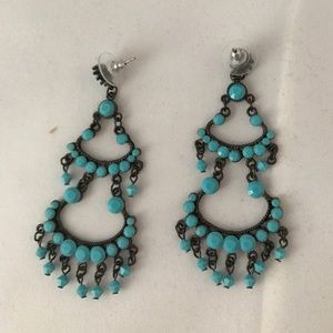 Earrings with faceted turquoise colored stones