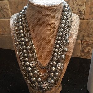 Silver necklace with varied texture.